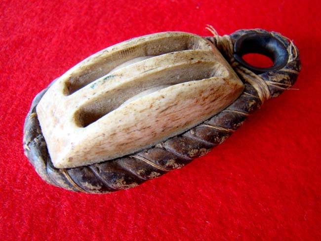 A carved whalebone double block with leather covered rope and brass grommet circa 1850-1870 — image 2